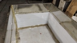 Milk cooler tank interior with paste bead sealing coil-to-wall joint