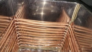 Dense copper coil winding inside a milk cooler tank before paste