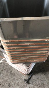 Close view of copper evaporator coils wrapping a water cooler tank