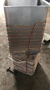 Stacked water cooler tanks with copper coil routing along the back