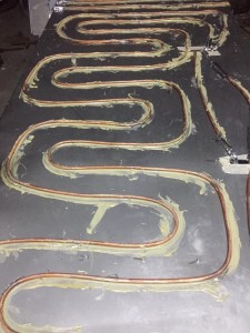 Thermal paste applied along the full length of a serpentine copper pipe