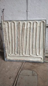 Defreezer panel with serpentine coil fully covered in thermal paste