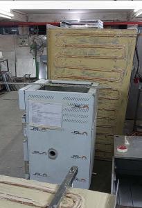 Defreezer body with serpentine coils fully pasted, standing in the workshop